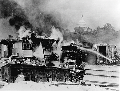 Figure 25.11 When the U.S. Senate denied early payment of their veteran bonuses, and Hoover ordered their makeshift camps cleared, the Bonus Army protest turned violent, cementing Hoover’s demise as a president. (credit: U.S. Department of Defense)