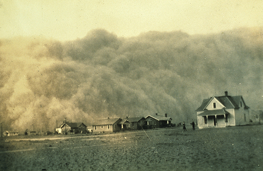 Figure 25.13 The dust storms that blew through the Great Plains were epic in scale. Drifts of dirt piled up against doors and windows. People wore goggles and tied rags over their mouths to keep the dust out. (credit: U.S. National Oceanic and Atmospheric Administration)