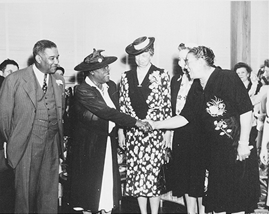 Figure 26.13 This photo of Eleanor Roosevelt and Mary McLeod Bethune (second from left) was taken at the opening of Midway Hall, a federal building to house female African American government workers. Bethune was sometimes criticized for working with those in power, but her willingness to build alliances contributed to success in raising money and support for her causes.