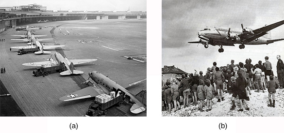 Figure 28.6 American C-47 transport planes (a) are loaded with staged supplies at a French airport before taking off for Berlin. Residents of Berlin wait for a U.S. plane (b) carrying needed supplies to land at Templehof Airport in the American sector of the city.