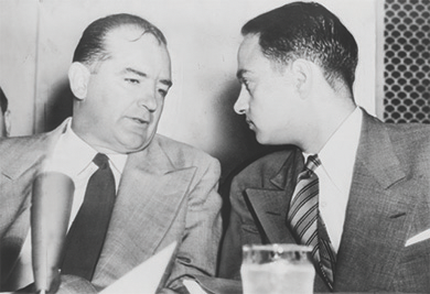 Figure 28.8 Senator Joseph McCarthy (left) consults with Roy Cohn (right) during the Army-McCarthy hearings. Cohn, a lawyer who worked for McCarthy, was responsible for investigating State Department libraries overseas for “subversive” books.