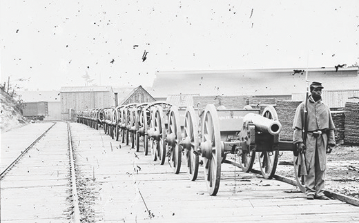 Figure 15.16 This 1865 daguerreotype illustrates three of the Union’s distinct advantages: African American soldiers, a stream of cannons and supplies, and an extensive railroad grid. (credit: Library of Congress)